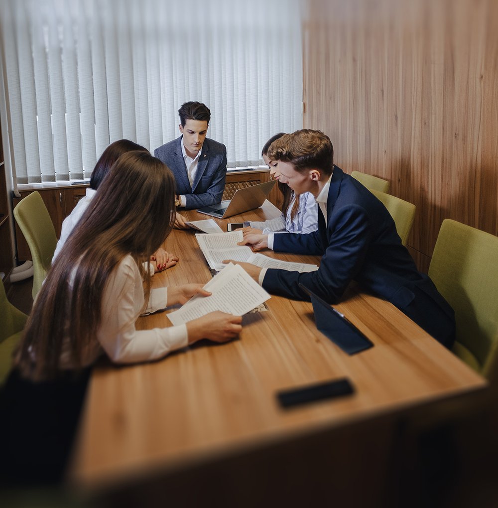 large team of people is working at one table for laptops, tablet » Montenegro Asociados » Montenegro Asociados